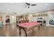 Spacious game room features a pool table, hardwood floors, ceiling fans, and a convenient wet bar area at 270 Blue Point Pkwy, Fayetteville, GA 30215
