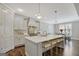 Well-appointed kitchen featuring a large island, white cabinets, and a stylish backsplash at 270 Blue Point Pkwy, Fayetteville, GA 30215