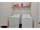 Practical laundry room featuring a washer, dryer, and overhead shelving at 270 Blue Point Pkwy, Fayetteville, GA 30215