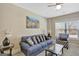 Bright living room featuring a blue sofa, patterned armchair, and an area rug at 270 Blue Point Pkwy, Fayetteville, GA 30215