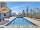 Backyard pool and patio area with umbrellas and seating for entertaining at 270 Blue Point Pkwy, Fayetteville, GA 30215