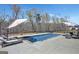 Backyard pool surrounded by lounge chairs, umbrellas, and wooded privacy at 270 Blue Point Pkwy, Fayetteville, GA 30215