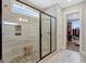 Stylish shower with stone pebble floor, frameless glass door, and tiled walls at 270 Blue Point Pkwy, Fayetteville, GA 30215