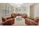 A cozy sitting room with leather chairs and a round ottoman for relaxing or reading at 270 Blue Point Pkwy, Fayetteville, GA 30215