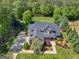 An aerial view of the home with a long drive, colorful landscaping, and mature trees at 249 Suffolk Way, Mcdonough, GA 30252