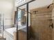 Bathroom featuring a jetted tub, walk in shower, and tile surround at 249 Suffolk Way, Mcdonough, GA 30252