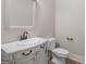 Elegant bathroom featuring a marble vanity with white sink, drawers and a toilet at 249 Suffolk Way, Mcdonough, GA 30252