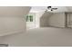 A spacious room with neutral walls and carpet features bright natural light and a modern ceiling fan at 249 Suffolk Way, Mcdonough, GA 30252