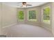 Spacious bedroom with large windows offering a view of the backyard and lush landscaping at 249 Suffolk Way, Mcdonough, GA 30252