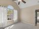 Vaulted bedroom featuring neutral carpet and walls plus bright natural light from the arched window at 249 Suffolk Way, Mcdonough, GA 30252