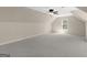 A spacious room with neutral walls and carpet features bright natural light and a modern ceiling fan at 249 Suffolk Way, Mcdonough, GA 30252