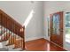 Elegant foyer with beautiful hardwood floors, staircase, and decorative glass door at 249 Suffolk Way, Mcdonough, GA 30252