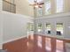 Spacious living room with soaring ceilings, hardwood floors, large windows with pool view and fireplace at 249 Suffolk Way, Mcdonough, GA 30252