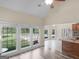 Bright living room with large windows overlooking the pool and kitchen bar area at 249 Suffolk Way, Mcdonough, GA 30252