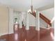 Open concept living space with hardwood floors, stately columns, and staircase at 249 Suffolk Way, Mcdonough, GA 30252