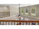 Bright open loft area featuring hardwood floors, large windows, and a ceiling fan at 249 Suffolk Way, Mcdonough, GA 30252