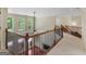Carpeted loft space with three large windows and a decorative iron railing at 249 Suffolk Way, Mcdonough, GA 30252