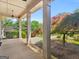 Covered porch view of lush landscaping and sculpted trees at 249 Suffolk Way, Mcdonough, GA 30252