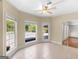 Bright sunroom with tile floor, ceiling fan, large windows with pool view, and direct access to backyard at 249 Suffolk Way, Mcdonough, GA 30252