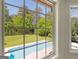 View from window of swimming pool and backyard with lush landscaping at 249 Suffolk Way, Mcdonough, GA 30252