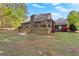 The back of the house has a wooden deck and a backyard surrounded by grass and trees at 105 Hartford Pl, Fayetteville, GA 30214