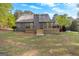 Exterior view of the house's backyard with a wooden deck and trees in the background at 105 Hartford Pl, Fayetteville, GA 30214