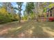 A view of the property from the backyard, featuring a deck and expansive green space at 105 Hartford Pl, Fayetteville, GA 30214