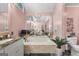 A pink bathroom with a bathtub, large mirror, and unique light fixture above at 105 Hartford Pl, Fayetteville, GA 30214