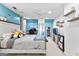 Vibrant bedroom featuring bright blue walls, unique decor, and a ceiling fan at 105 Hartford Pl, Fayetteville, GA 30214