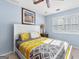 Bedroom with light blue walls, shuttered windows, and a comfortable bed with patterned bedding at 105 Hartford Pl, Fayetteville, GA 30214