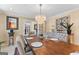 Elegant dining room with a long wooden table, upholstered chairs, and a decorative chandelier at 105 Hartford Pl, Fayetteville, GA 30214