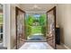 Inviting front door of a beautiful home, framed by lush greenery and a well-manicured lawn at 105 Hartford Pl, Fayetteville, GA 30214