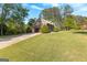 Spacious garage with a driveway and expansive green lawn of a charming home at 105 Hartford Pl, Fayetteville, GA 30214