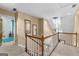 Second story hallway landing overlooking front door and features a decorative light fixture at 105 Hartford Pl, Fayetteville, GA 30214