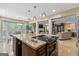 Large kitchen island with cooktop, bar seating, and open views to dining and living areas at 105 Hartford Pl, Fayetteville, GA 30214