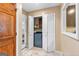 A laundry area with an included washer, white folding doors, and natural light at 105 Hartford Pl, Fayetteville, GA 30214