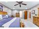 Relaxing main bedroom with a large bed, natural wood furniture, and access to an ensuite bathroom at 105 Hartford Pl, Fayetteville, GA 30214