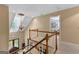 Second story staircase landing overlooking front door and features a decorative light fixture at 105 Hartford Pl, Fayetteville, GA 30214