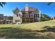 Expansive backyard view showcasing the home's deck, patio, and lush lawn space at 1730 Carlington Ct, Grayson, GA 30017