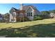 Large backyard featuring a covered deck with stairs and a spacious grassy area at 1730 Carlington Ct, Grayson, GA 30017