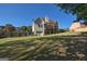 Large backyard with lawn, partial fencing, and a home featuring a deck, patio, and garage at 1730 Carlington Ct, Grayson, GA 30017