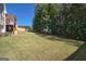 A large, lush backyard, partially enclosed by a wooden fence, offers ample space and privacy at 1730 Carlington Ct, Grayson, GA 30017