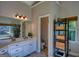 Bright bathroom with dual vanity, a large mirror, and a view of the backyard at 1730 Carlington Ct, Grayson, GA 30017