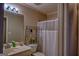 Cozy bathroom with a sink, toilet, and bathtub with shower curtain at 1730 Carlington Ct, Grayson, GA 30017