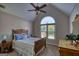 Charming bedroom featuring vaulted ceilings, wooden furnishings, and natural light at 1730 Carlington Ct, Grayson, GA 30017