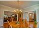 Elegant dining room featuring a chandelier, hardwood floors, and access to the living room at 1730 Carlington Ct, Grayson, GA 30017