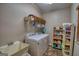 Bright laundry room featuring a washing machine, dryer, shelving, and ample storage space at 1730 Carlington Ct, Grayson, GA 30017