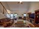 Cozy living room with a fireplace, leather seating, and ample natural light at 1730 Carlington Ct, Grayson, GA 30017