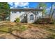 View of backyard featuring a two-story house with neutral siding and lawn at 3139 Players Dr, Jonesboro, GA 30236