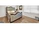 Cozy bedroom featuring hardwood floors, neutral walls, a large window, and a decorative headboard at 3139 Players Dr, Jonesboro, GA 30236